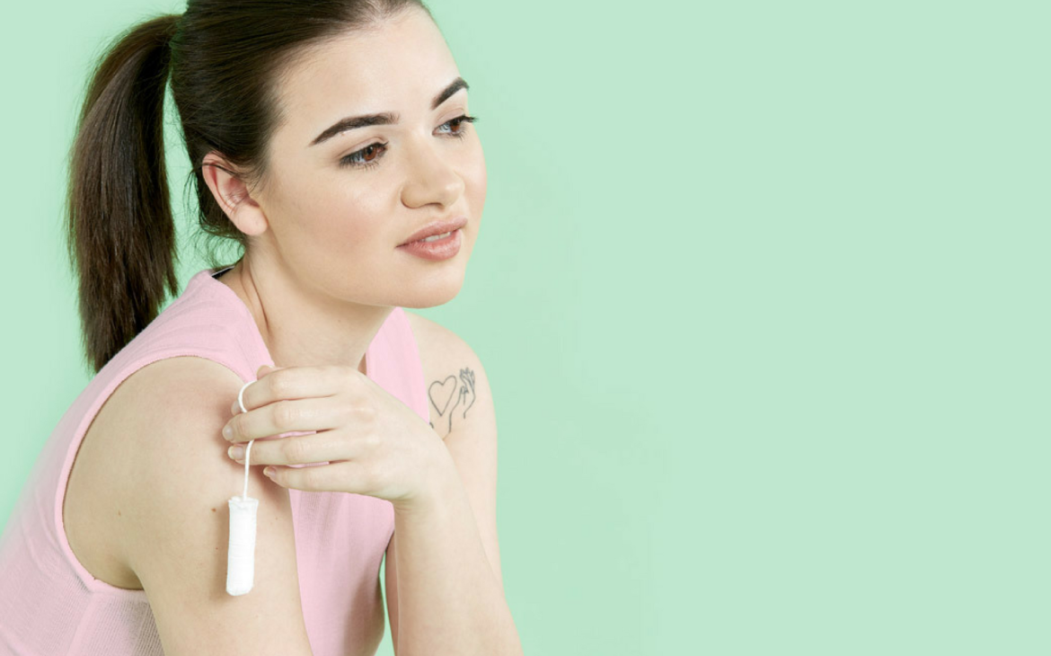 Girl holding eco-friendly period care tampon